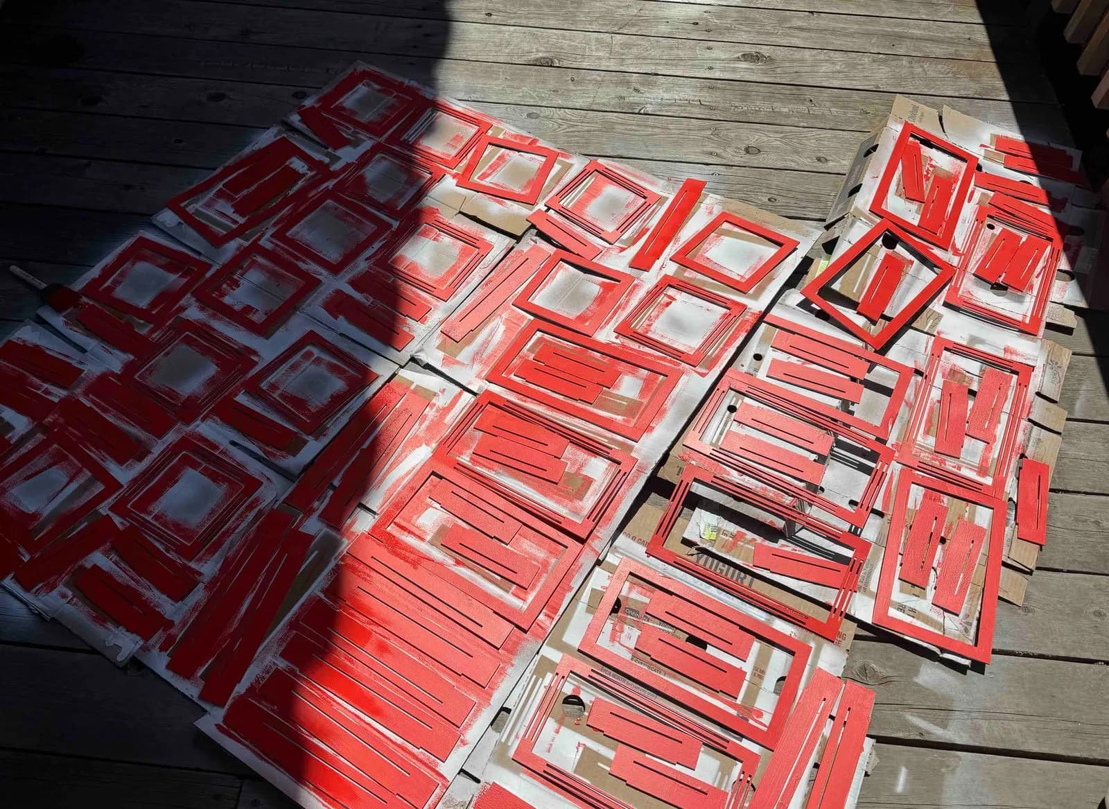 floor covered in pieces being painted red