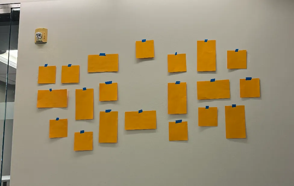 paper versions of boxes taped to the wall