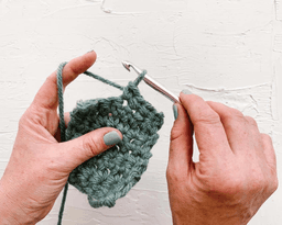 person crochetting