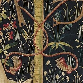 detail view of a gold and red rope wrapped around a pair of initials on the tapestry